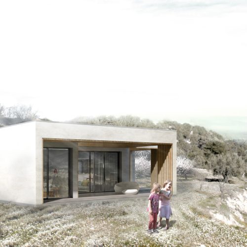 Fachada principal de vivienda modular con entramado ligero de madera en entorno rural, proyectada por arquitecto en Valencia