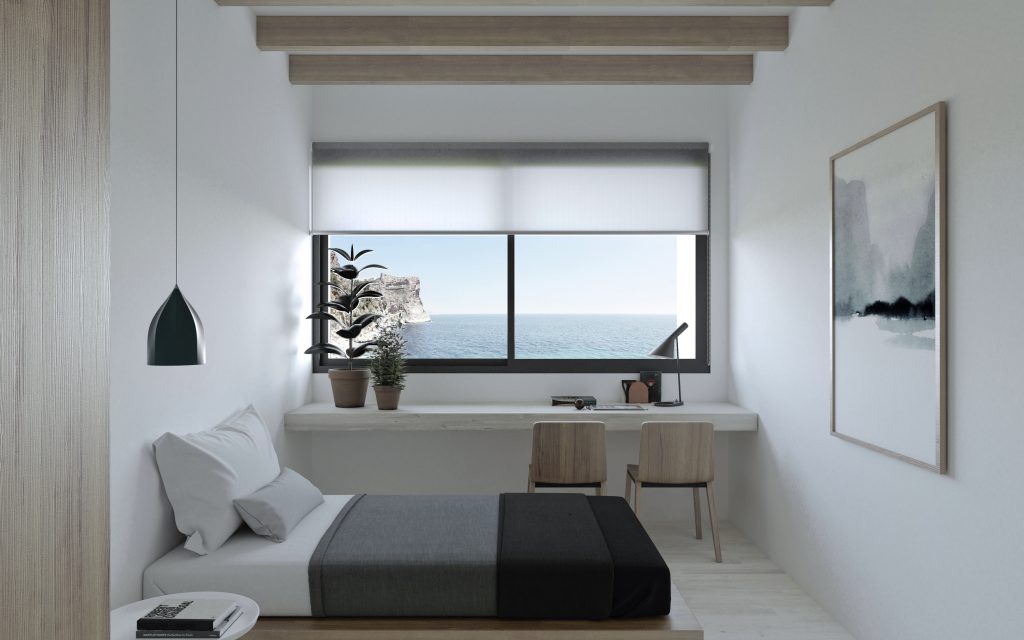 Dormitorio con escritorio y ventana panorámica al mar en casas modulares Valencia proyectada por Alfaro Arquitectos