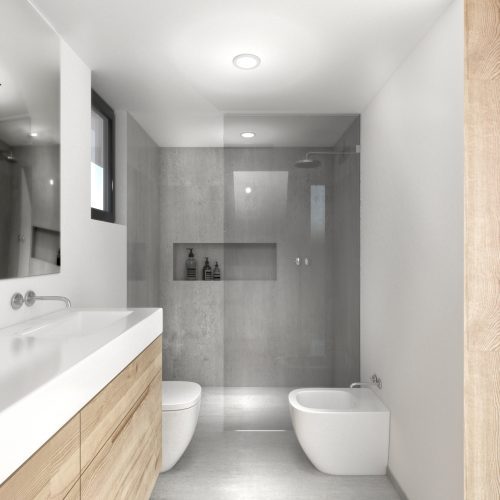 Baño con ducha a ras de suelo y mobiliario de madera natural en vivienda modular proyectada por contratar arquitecto en Valencia